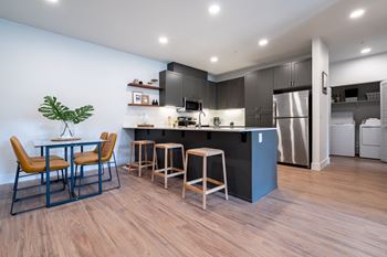 A kitchen and dining area with a table and chairs